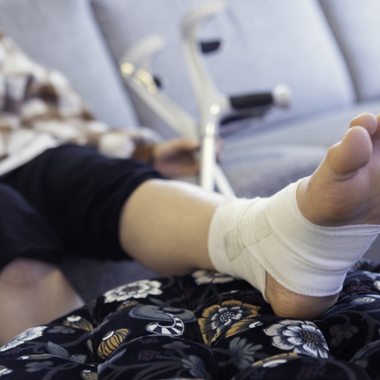 injured person reclining on a couch